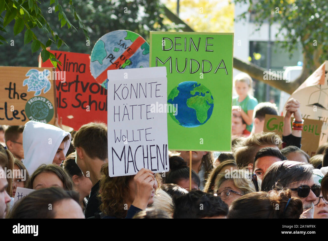 Protest sign saying `Could. Might. Would. Do!` in German held up by young people during Global Climate Strike / Fridays for future Stock Photo